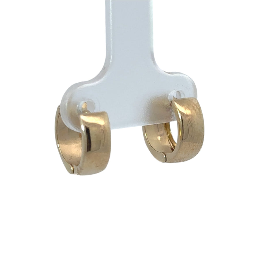 Delicate gold baby earrings shown on soft background
