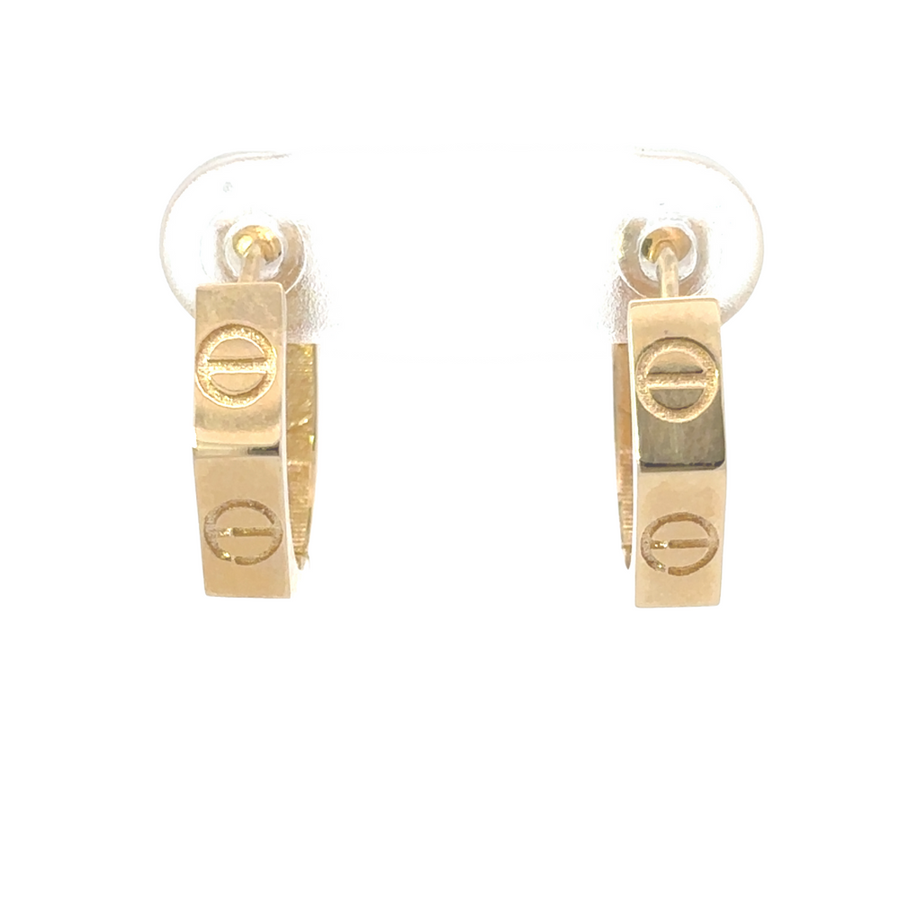 Close-up of 14k gold huggie earrings with a polished finish on a white background.