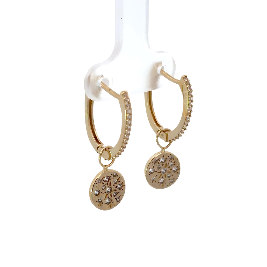 Close-up of 14k gold huggies with cubic zirconia sparkle