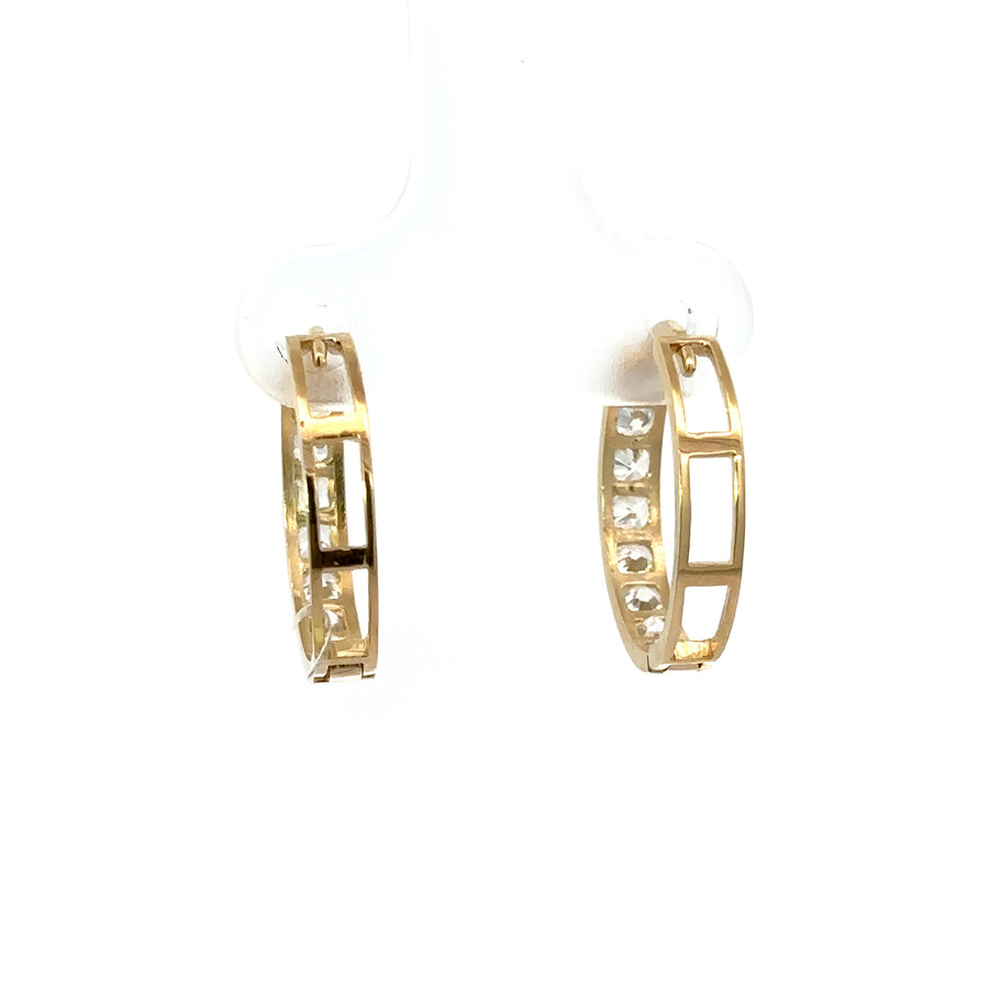 Woman wearing sparkling gold huggies with CZ line