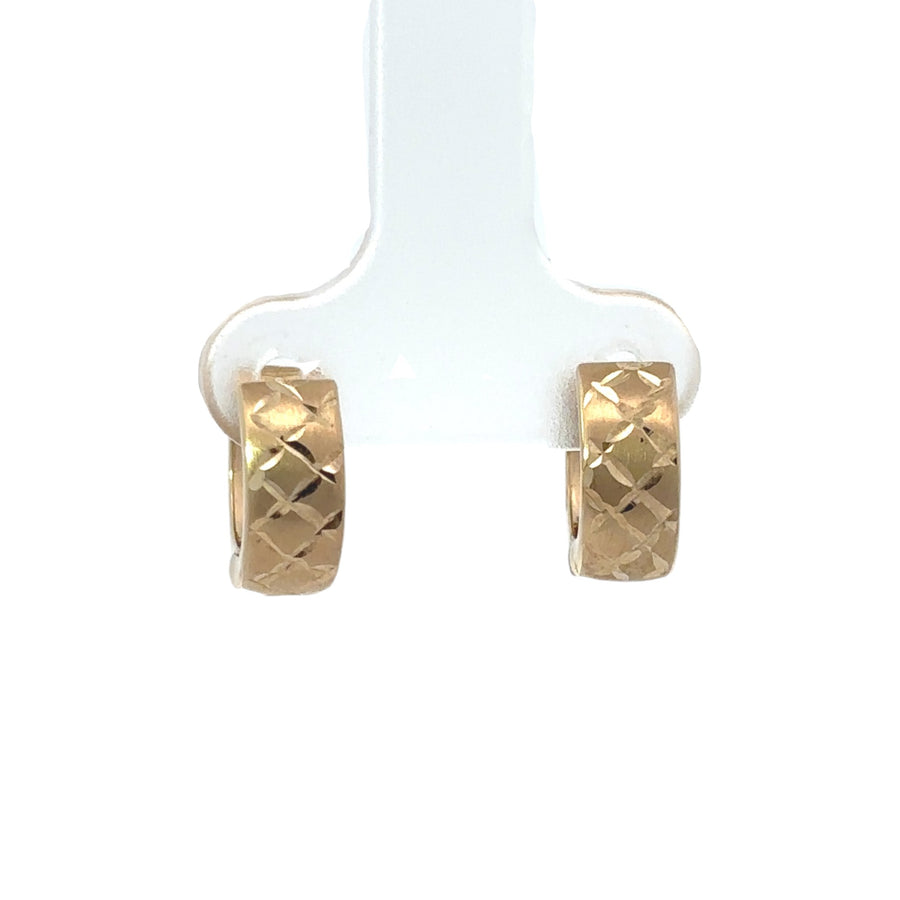 Small gold hoop earrings featuring a modern X design