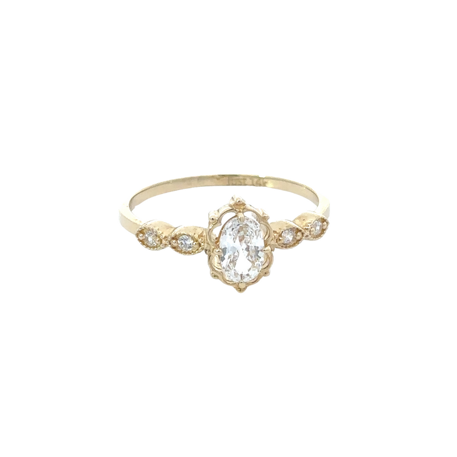 Flat-lay of 14k gold necklace, ring, and earrings set, arranged elegantly to show off the matching design.