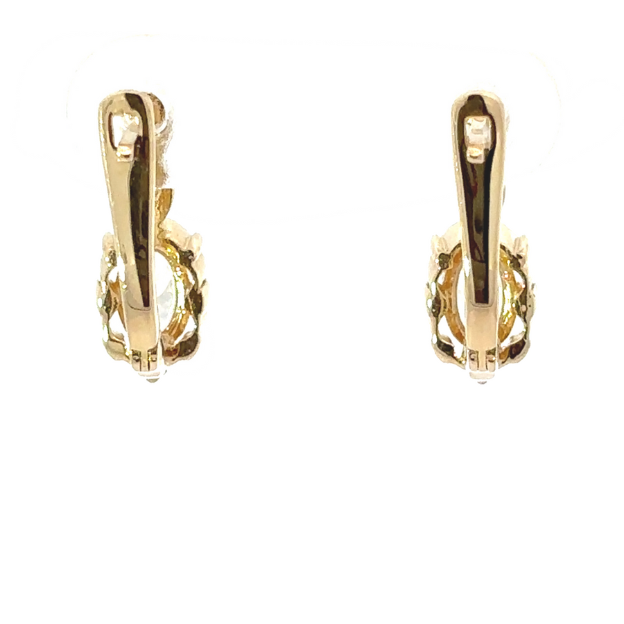 Detailed shot of 14k gold earrings with oval center stones, highlighting the craftsmanship and shine.