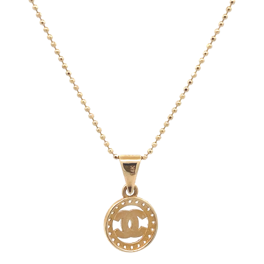 Flat-lay of ring displayed beside soft gold accessories