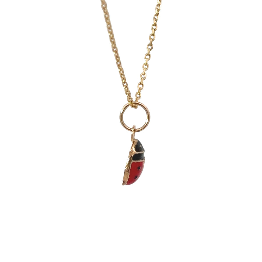 Close-up of mini lady bag pendant in 14k gold