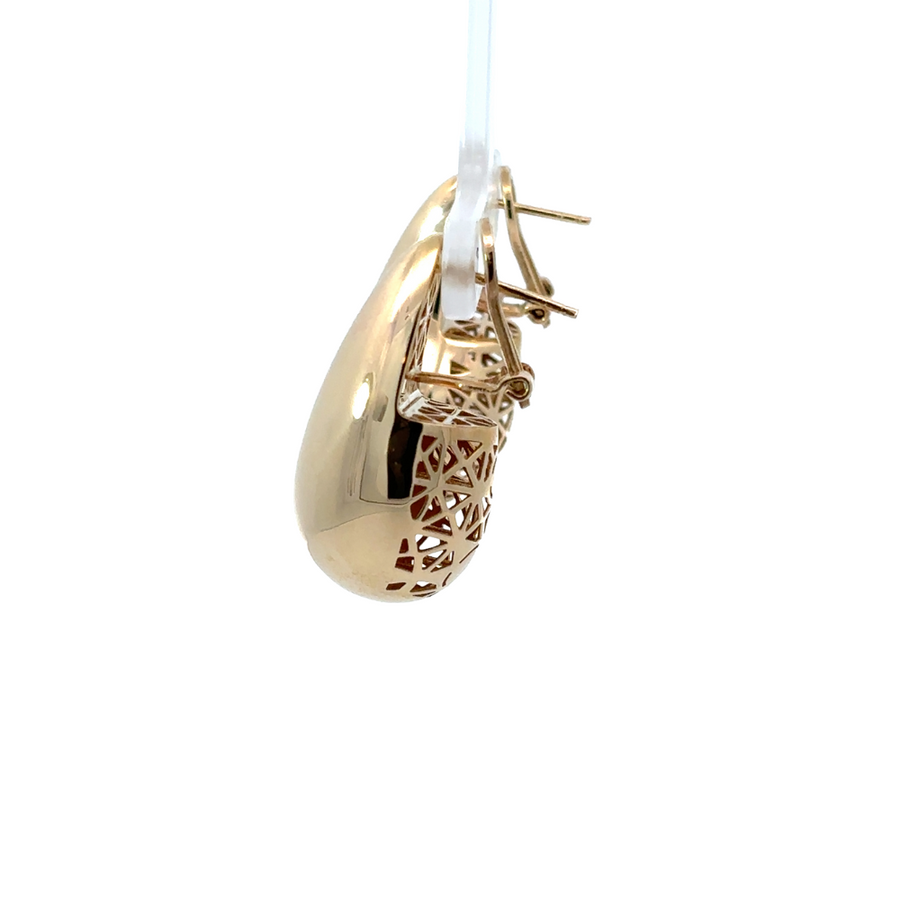 Model wearing the 14k gold large drop earrings, showcasing their graceful, elongated shape.