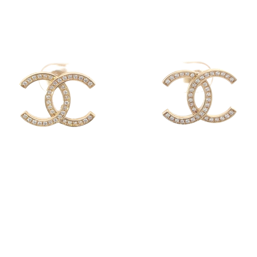 Close-up of large 14k gold earrings with sparkling CZ stones, highlighting the detailed craftsmanship