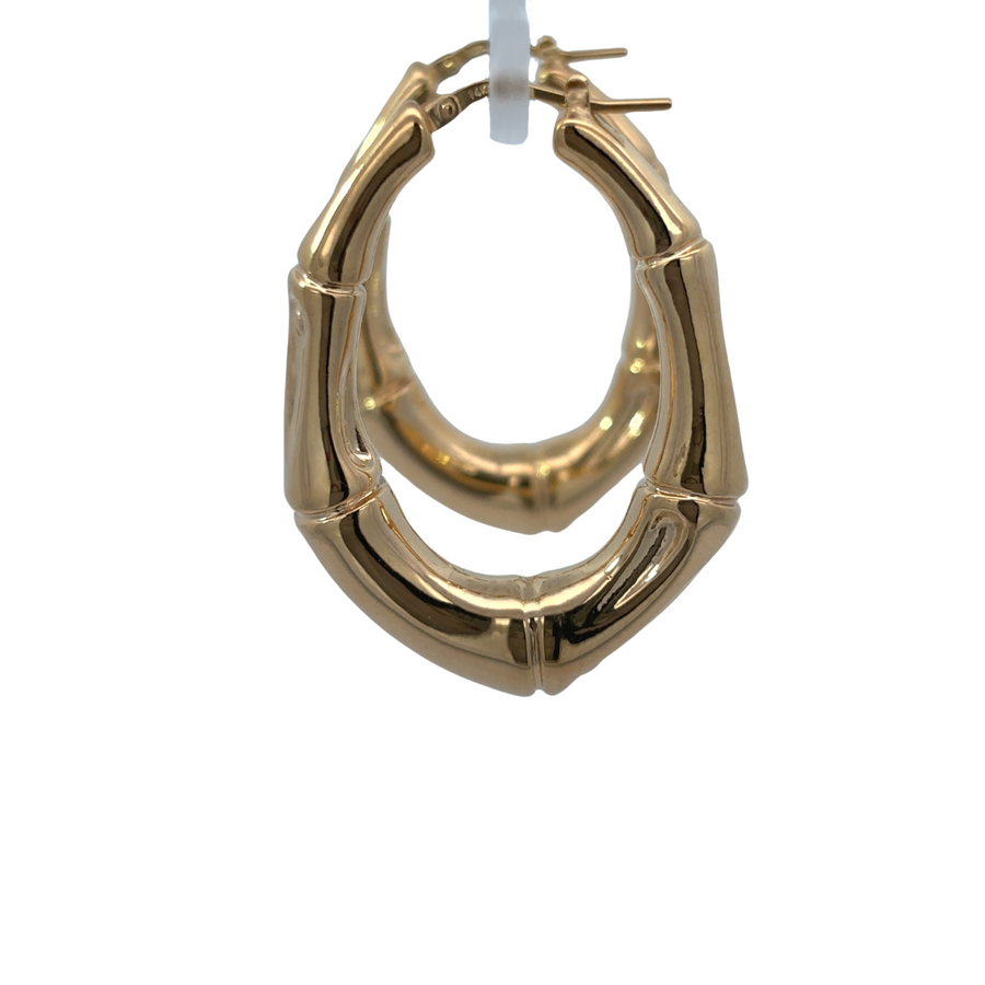 Close-up of bamboo-inspired texture on gold earrings