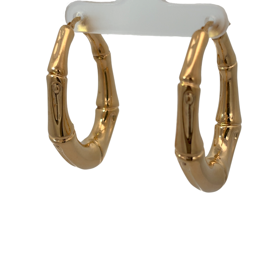 14k gold oval bamboo-style earrings on white background