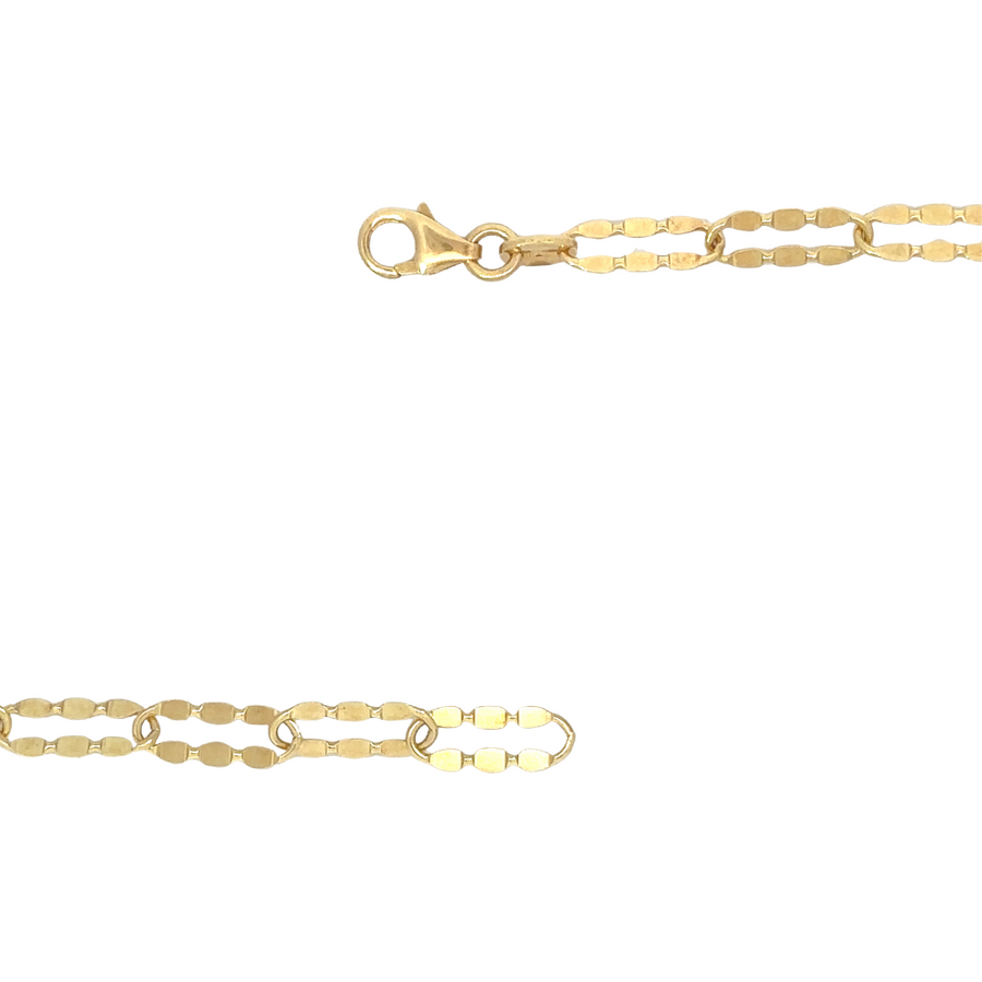 14k gold long shine chain displayed on a velvet tray, emphasizing polished glow