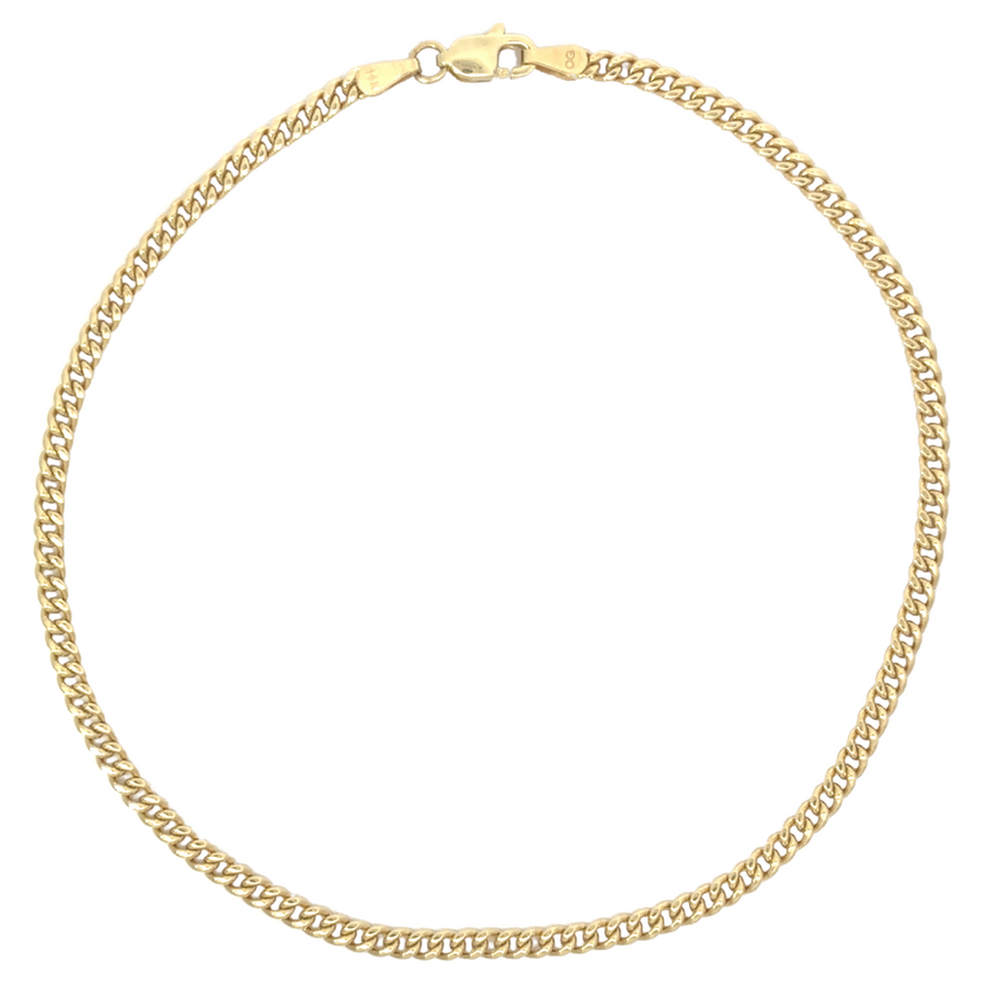 Close-up view of 14k gold men's bracelet with a high-polish finish on a dark surface