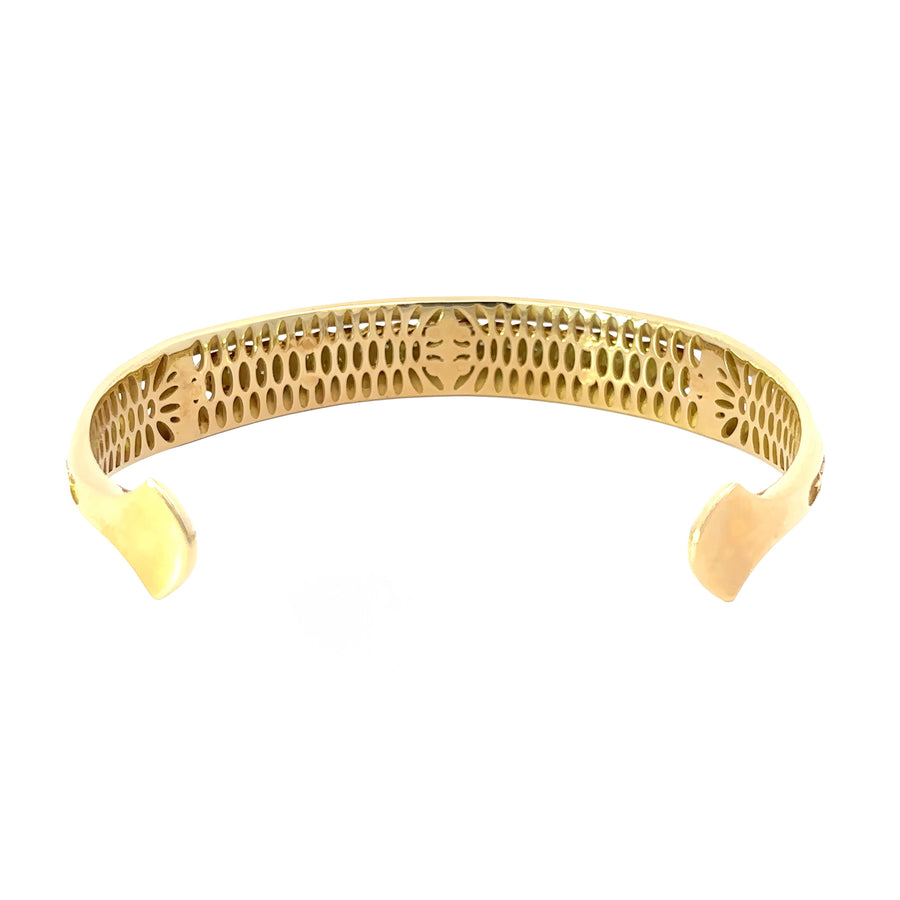 Side view of diamond-studded open bangle in 14k gold