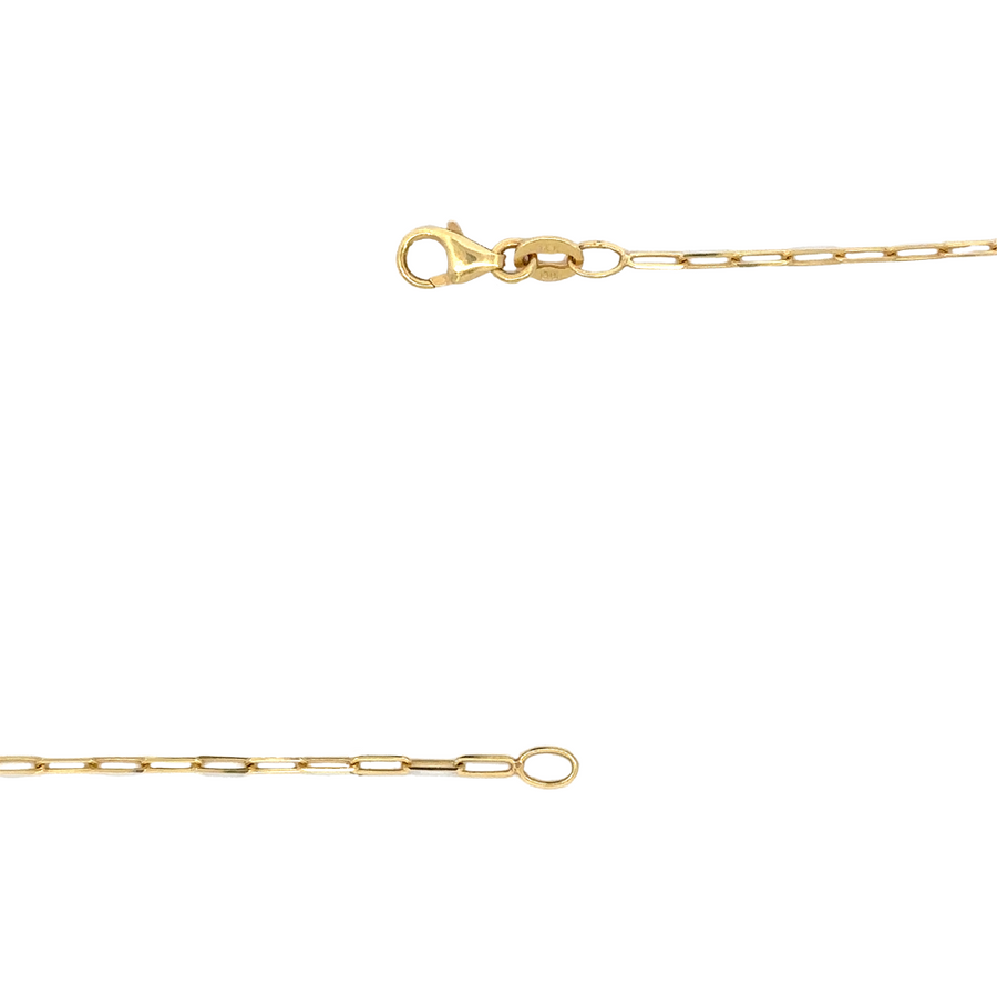 14k gold necklace coiled on a neutral fabric surface