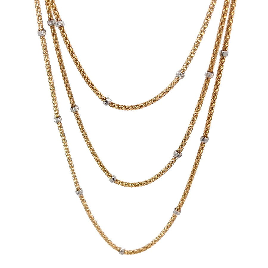 14k gold two-tone necklace with 45 small circular links on white background