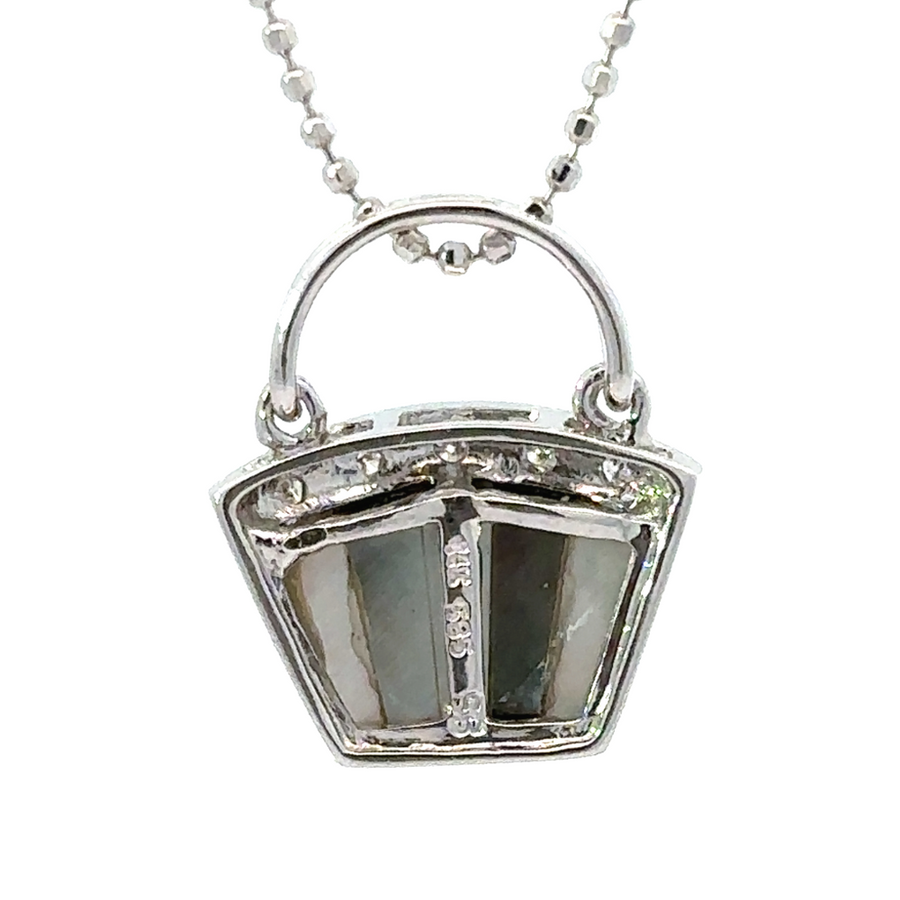 Side view of delicate gold necklace with diamond accents