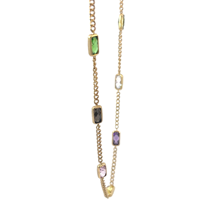 Model wearing the 14k gold necklace, showcasing the necklace's elegant drape around the neckline.