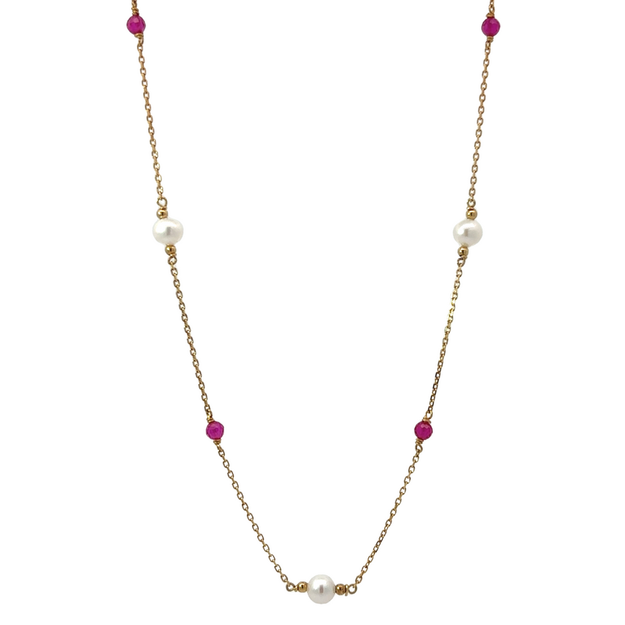 Model wearing 14k gold necklace with 4 stones and 3 pearls, adjustable length