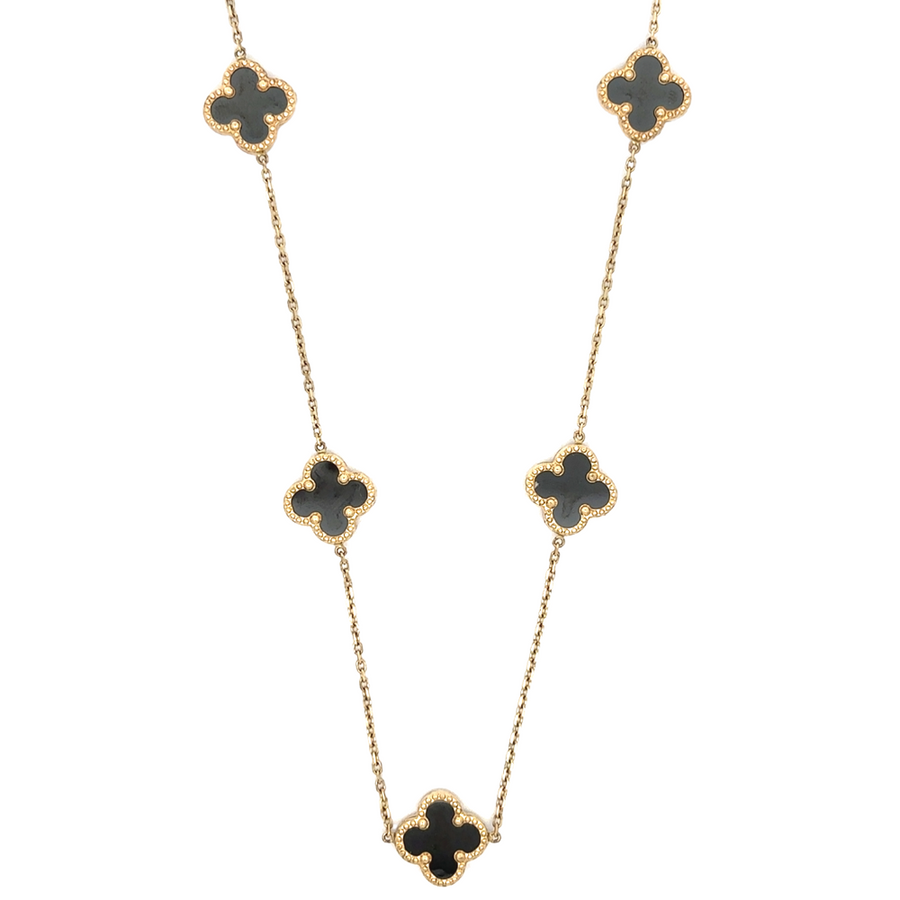 14k gold necklace with nine black accents on a white background