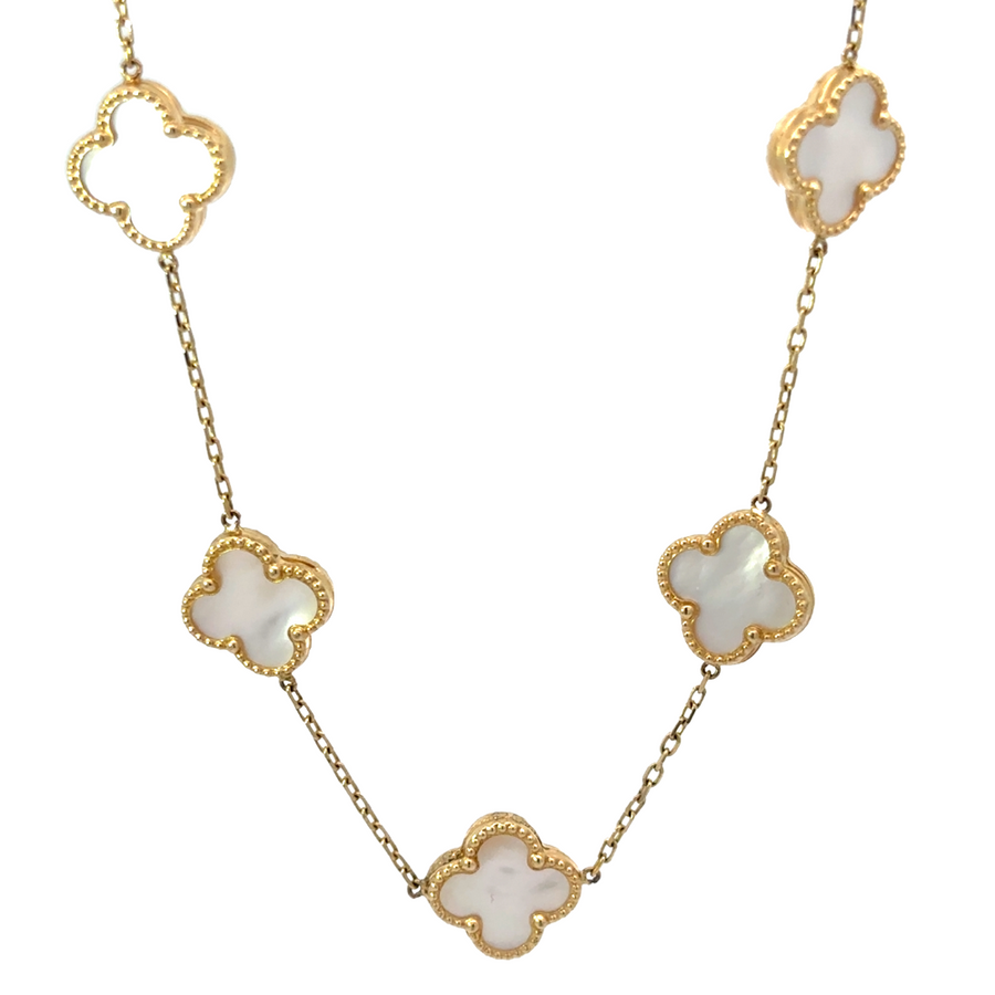 Detailed shot of 9 white stones set in 14k gold necklace for women
