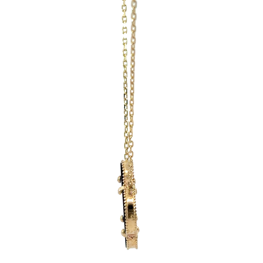 Adjustable gold necklace with black accent shown on a jewelry display