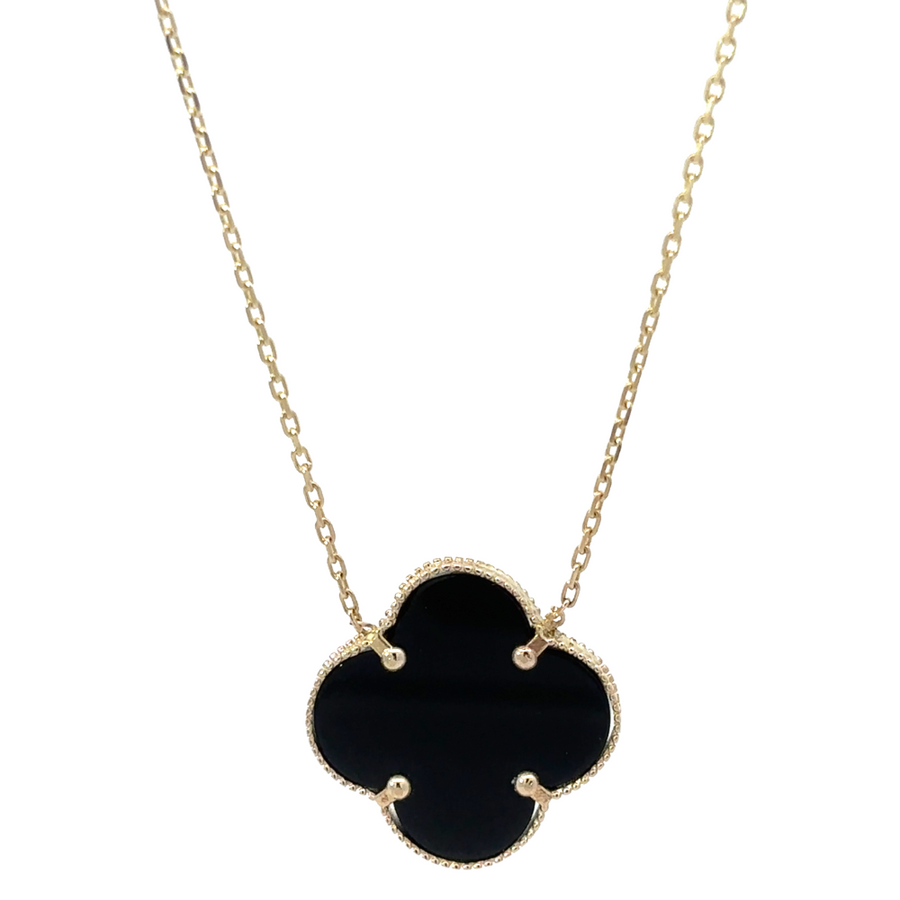 Close-up of 14k gold necklace with sleek black accent detailing