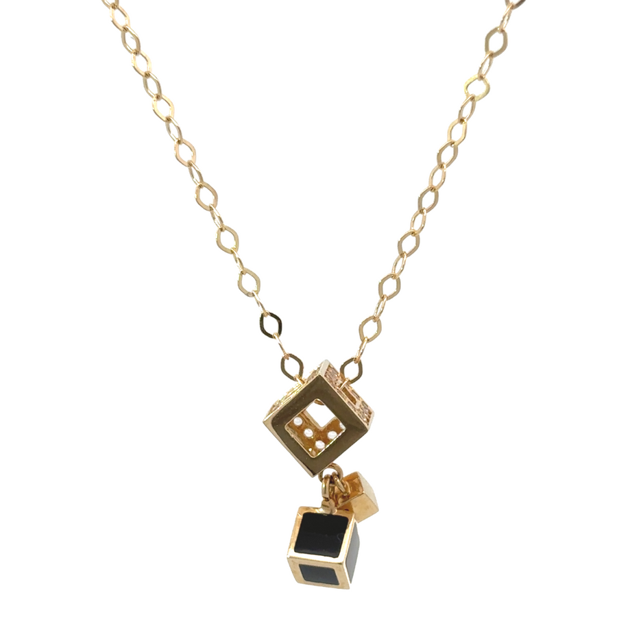 Elegant women's necklace with black cube charm on a gold chain