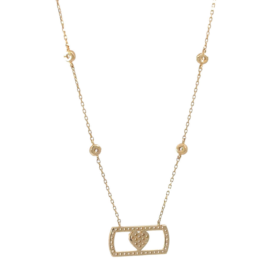 14k gold necklace with CZ stones laid on luxurious fabric