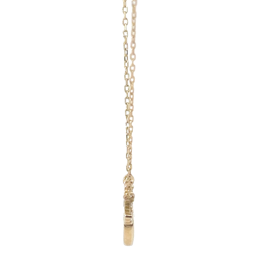 Flat-lay image of the 14k gold necklace, focusing on the heart-shaped pendant and minimalist design.