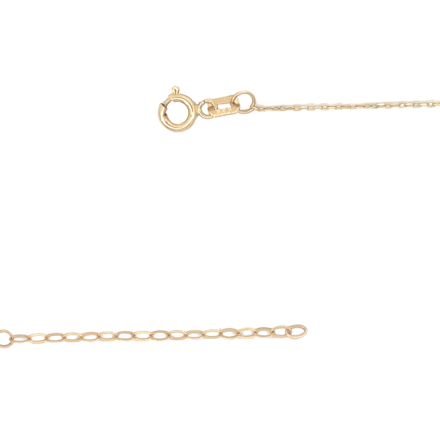 Lifestyle image of a woman wearing the 14k gold necklace with heart charm, paired with a casual outfit.