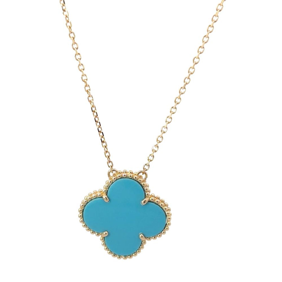 Close-up of 14k gold necklace with center turquoise stone on white background