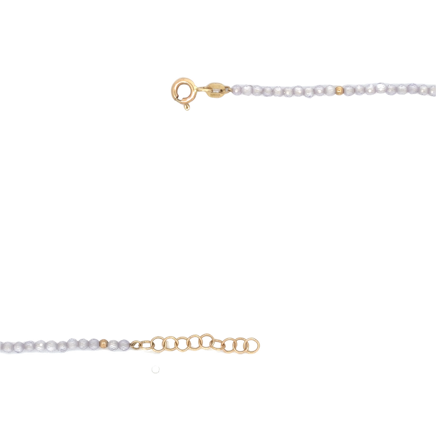 Elegant jewelry box display of 14k gold necklace with corundum stone