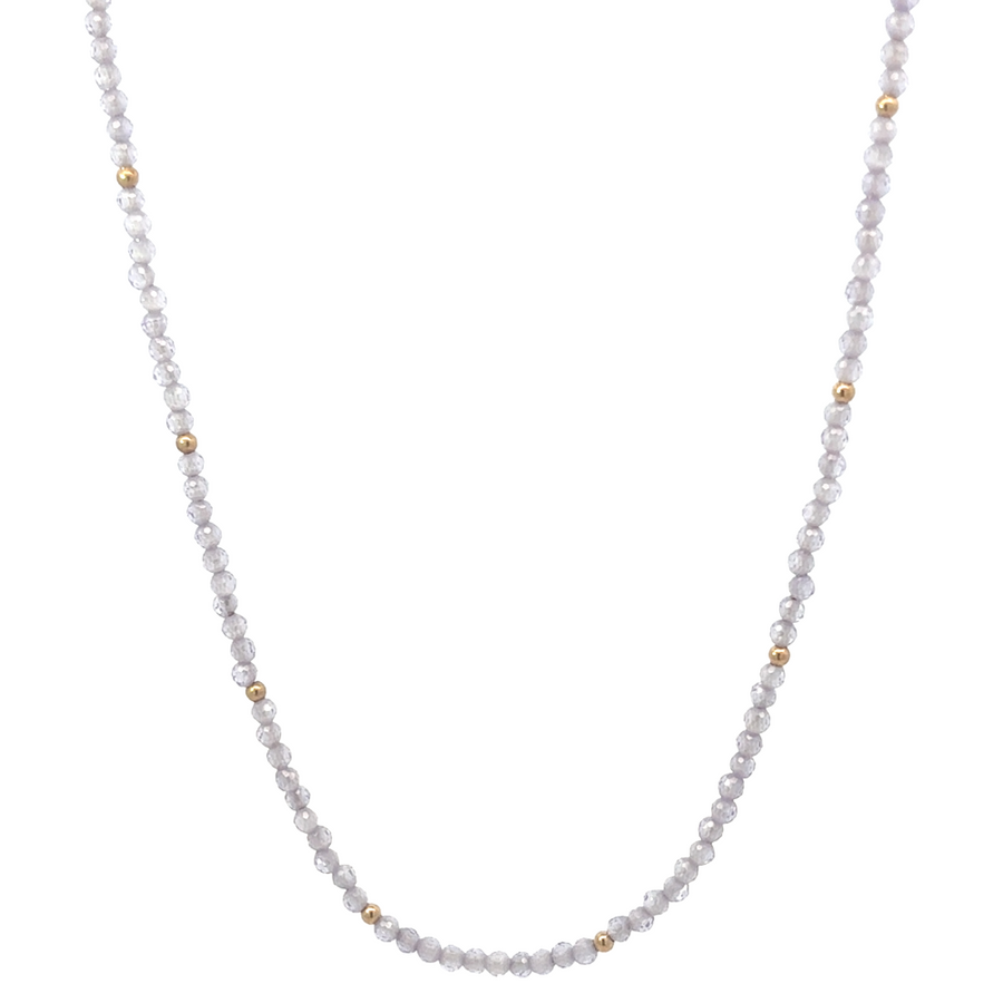Detailed view of the corundum gemstone set in polished gold