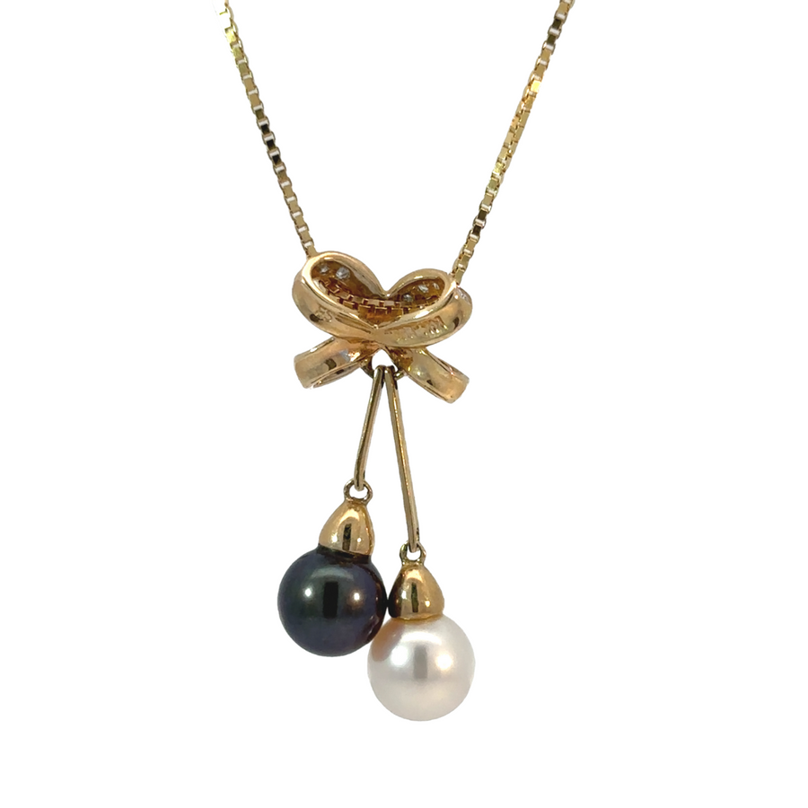 Necklace displayed on white surface highlighting diamond and pearl d