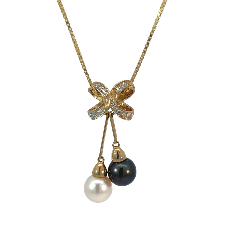 14k gold necklace with diamond and pearl pendant close-up