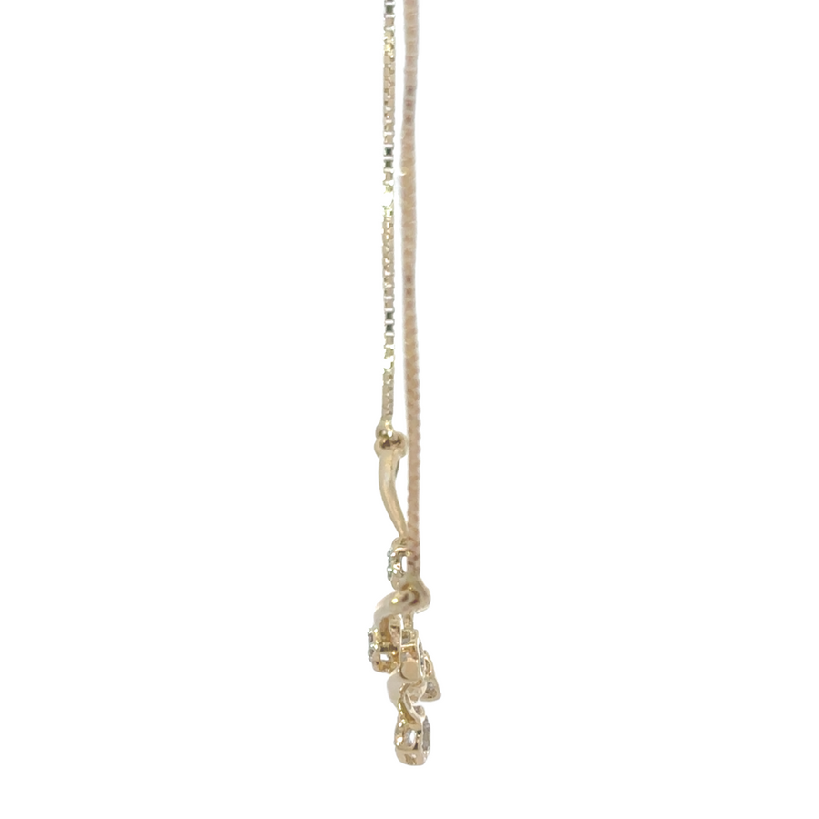 Diamond-accented 14k gold chain on fabric background