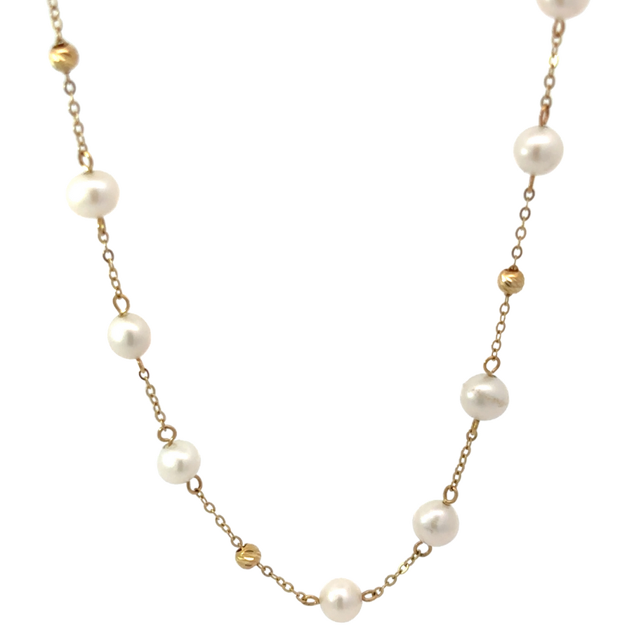 14k gold necklace with pearls and gold balls displayed on velvet bust