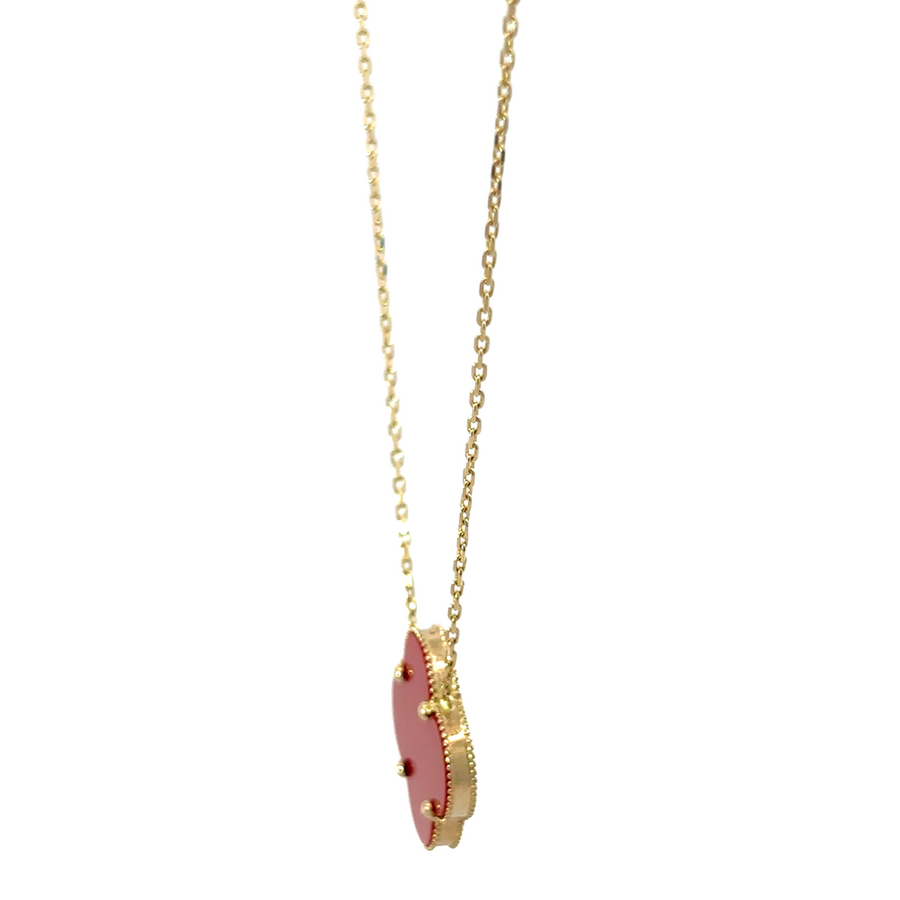 Side view of 14k gold necklace with red accent, worn as a statement piece for women’s fashion.