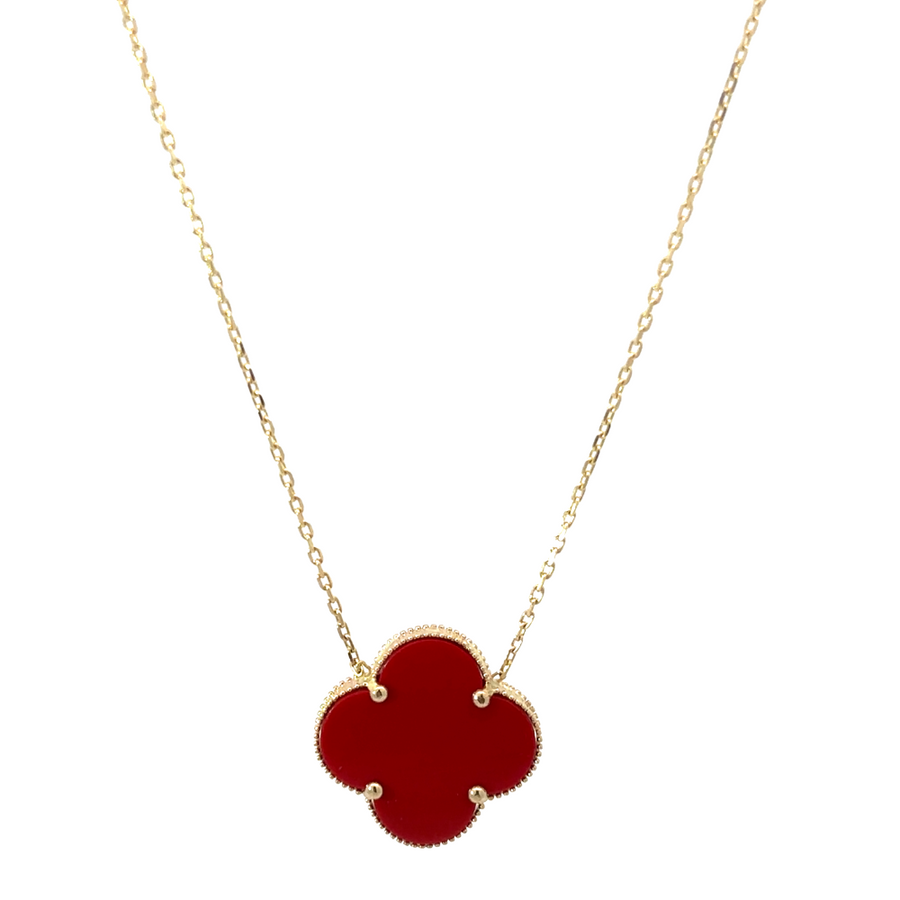Close-up of the 14k gold necklace with red accent, showcasing the vibrant red gemstone and classic gold design.