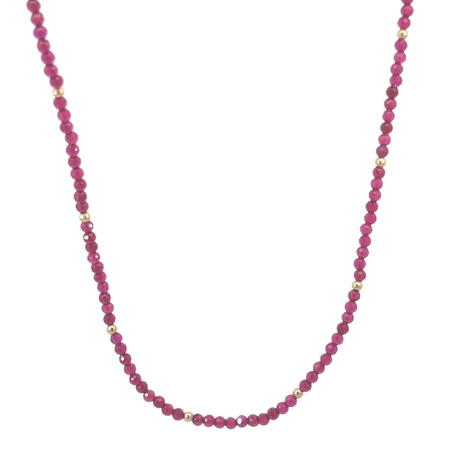 14k gold necklace with red corundum stone on white background