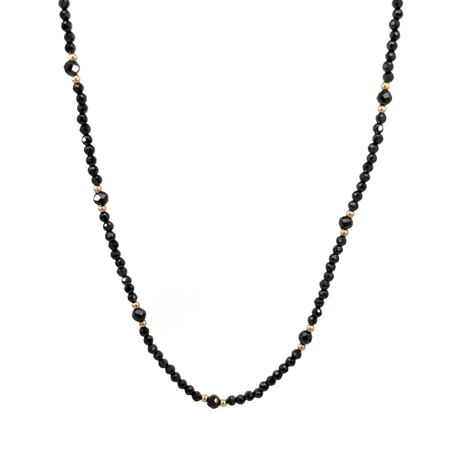 Close-up of synthetic stones on a delicate 14k gold necklace