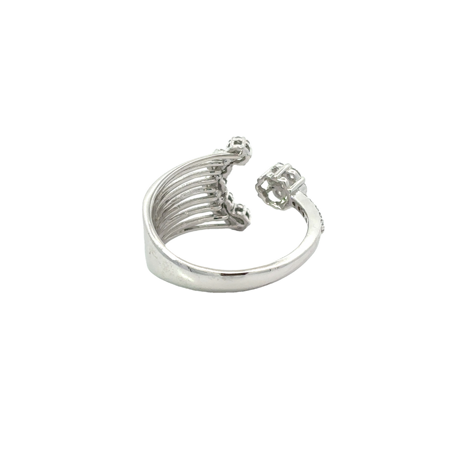 Ring worn on finger, showcasing open design and diamonds