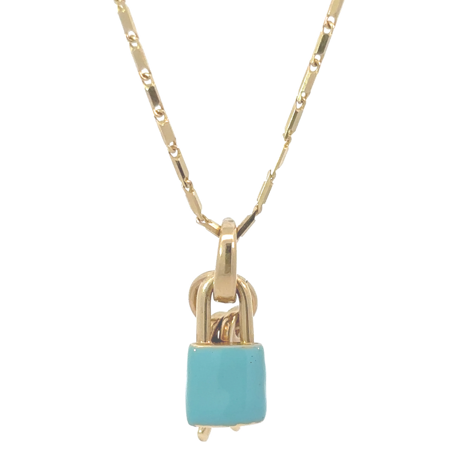 14k gold pendant in a gift box with blue enamel and gold key accents