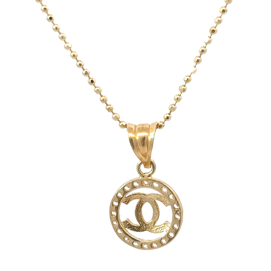 Gold pendant with cubic zirconia styled on a chain for a unisex look