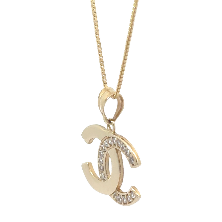 Pendant hanging from fine gold chain on a neutral display bust