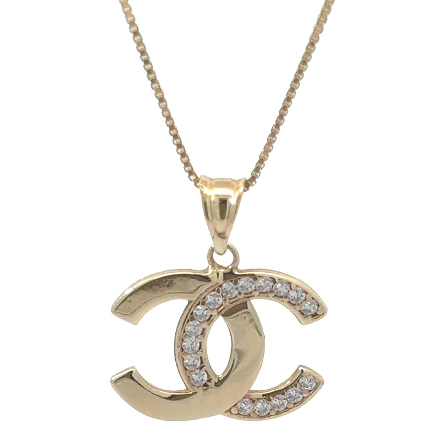 Close-up of 14k gold unisex pendant with cubic zirconia on white background