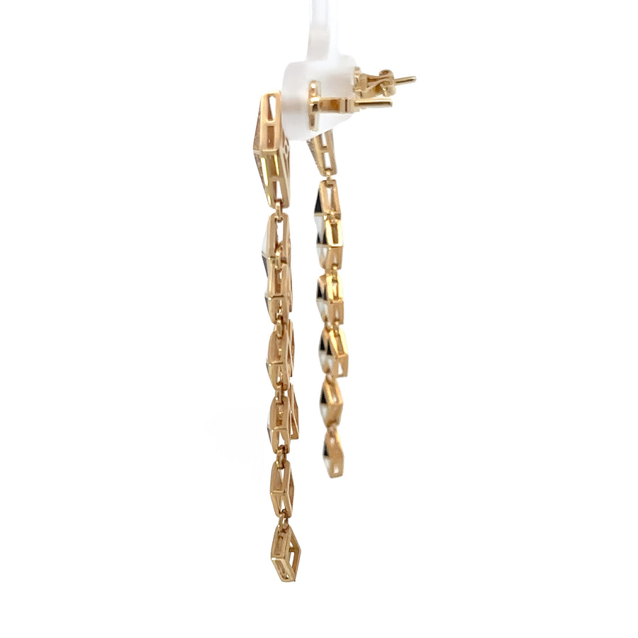 Bold rhombus-shaped gold earrings on white background