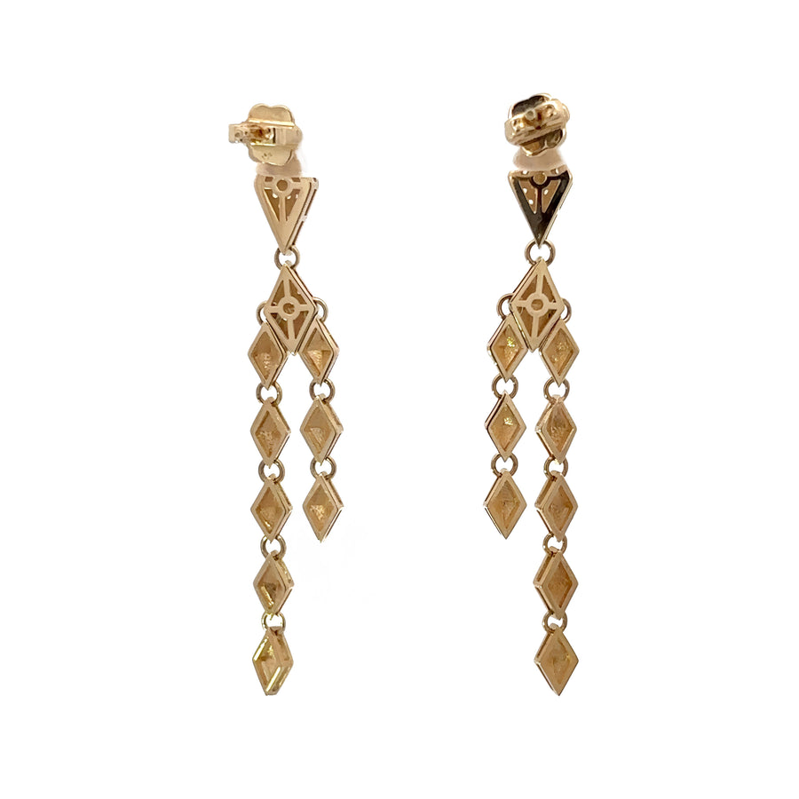 Side angle of 14k gold earrings with modern black and white design