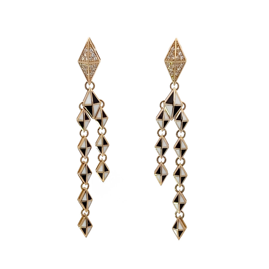 Close-up of geometric gold earrings with color contrast