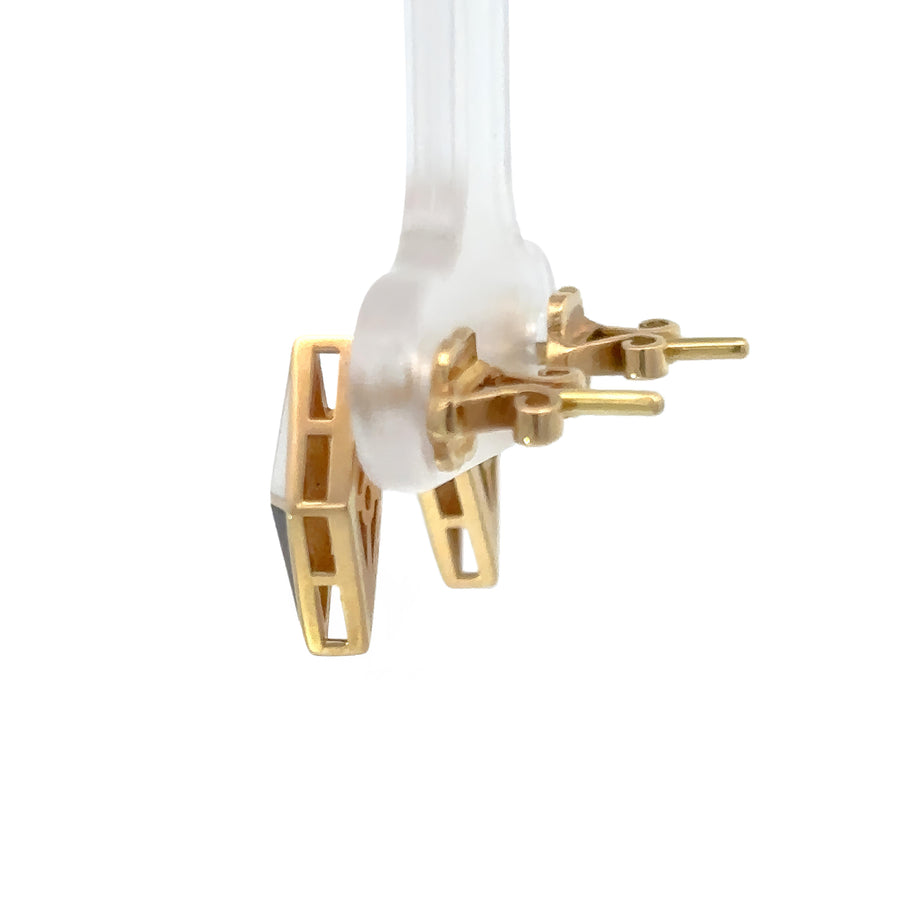 Detailed shot of black and white accents on 14k gold rhombus studs