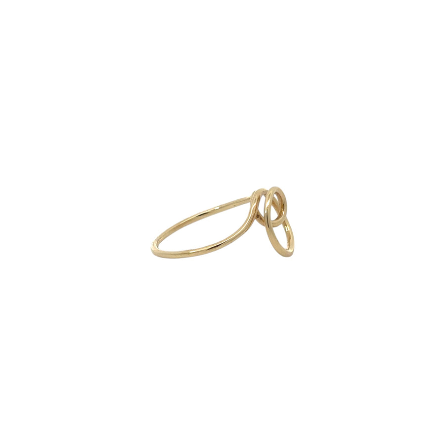 Close-up of shiny gold ring on white background